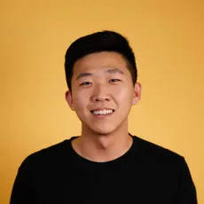 Ricky X. Yang, photographed against a yellow backdrop.